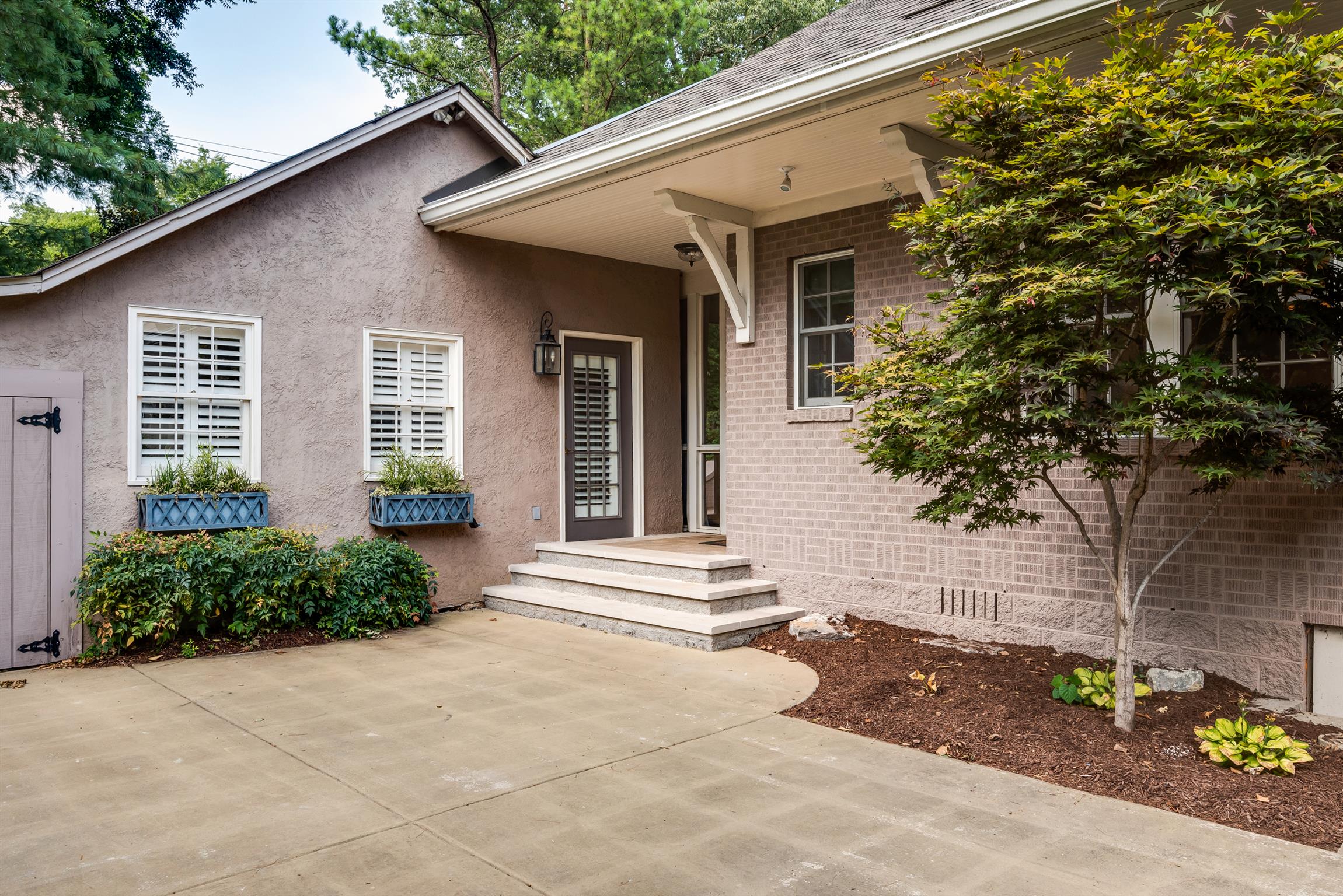 3904 Valley Road Nashville, TN 37205 - Photo 19 of 25 a front view of a house with a yard and potted plants