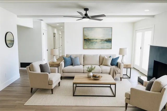 a living room with furniture a rug and a chandelier