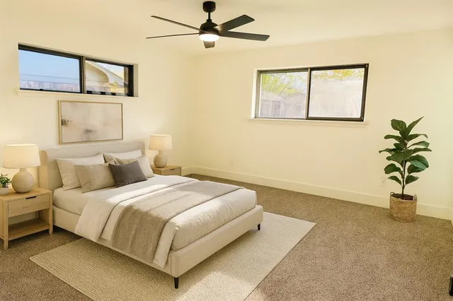 a bedroom with a bed and a window