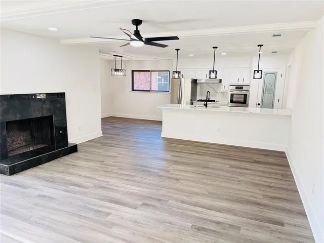 a view of a house with a big yard and large trees