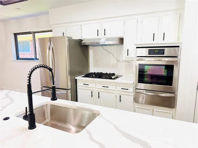 a view of a house with a backyard and chairs