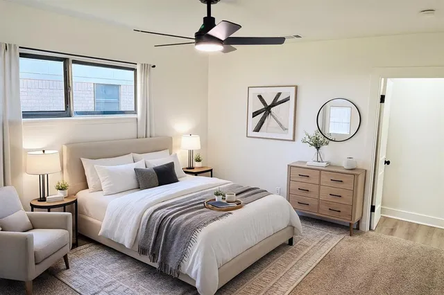 a spacious bedroom with a bed and wooden floor