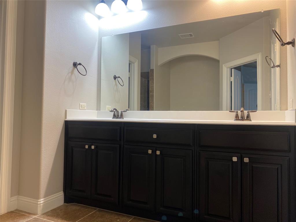 4232 Charles Road Carrollton, TX 75010 - Photo 15 of 21 a bathroom with a double vanity sink and a mirror