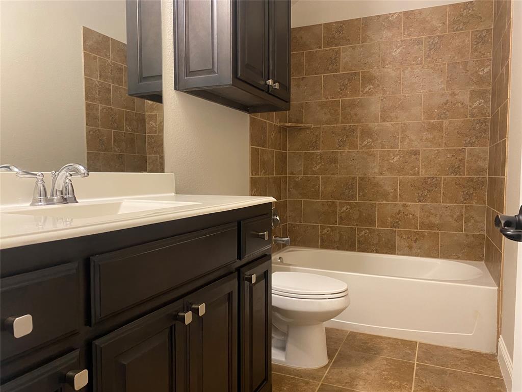 4232 Charles Road Carrollton, TX 75010 - Photo 19 of 21 a bathroom with a sink a toilet and shower