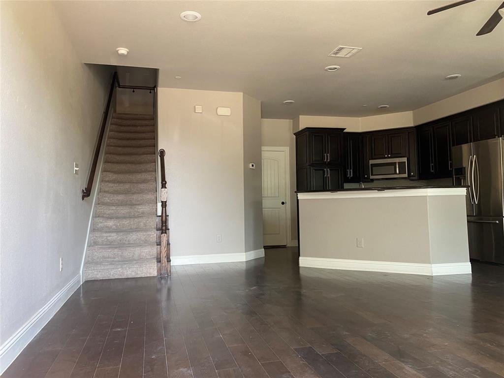 4232 Charles Road Carrollton, TX 75010 - Photo 4 of 21 a view of a kitchen with wooden floor and stairs