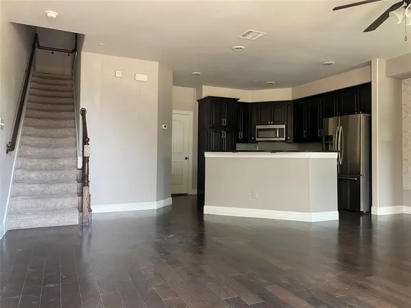 a view of kitchen with stainless steel appliances cabinets and wooden floor