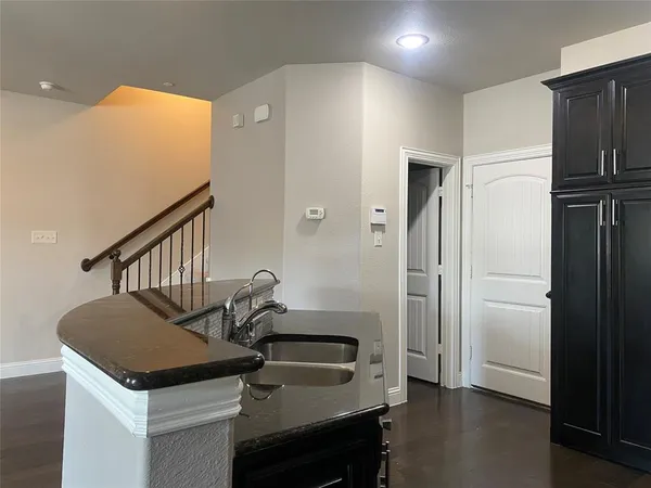 a view of hallway with stairs and wooden floor
