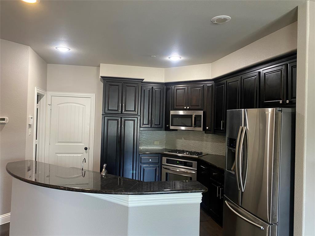4232 Charles Road Carrollton, TX 75010 - Photo 10 of 21 a kitchen with stainless steel appliances granite countertop a refrigerator and a stove top oven
