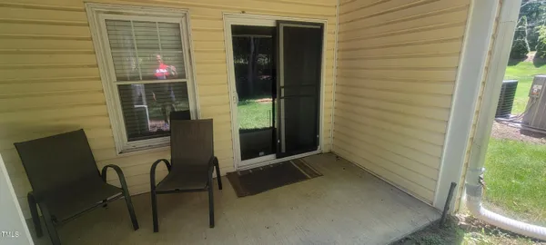 a balcony with table and chairs