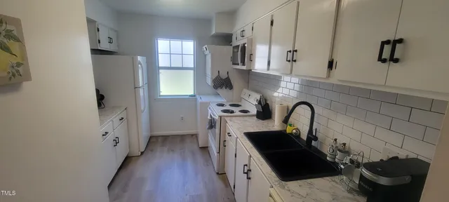 a kitchen with stainless steel appliances a sink stove and cabinets
