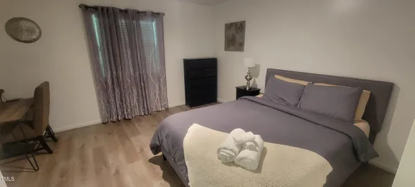 a bedroom with a bed and a chair