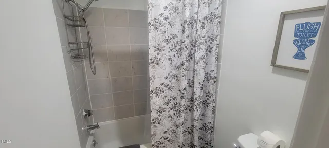 a bathroom with a shower curtain and a sink