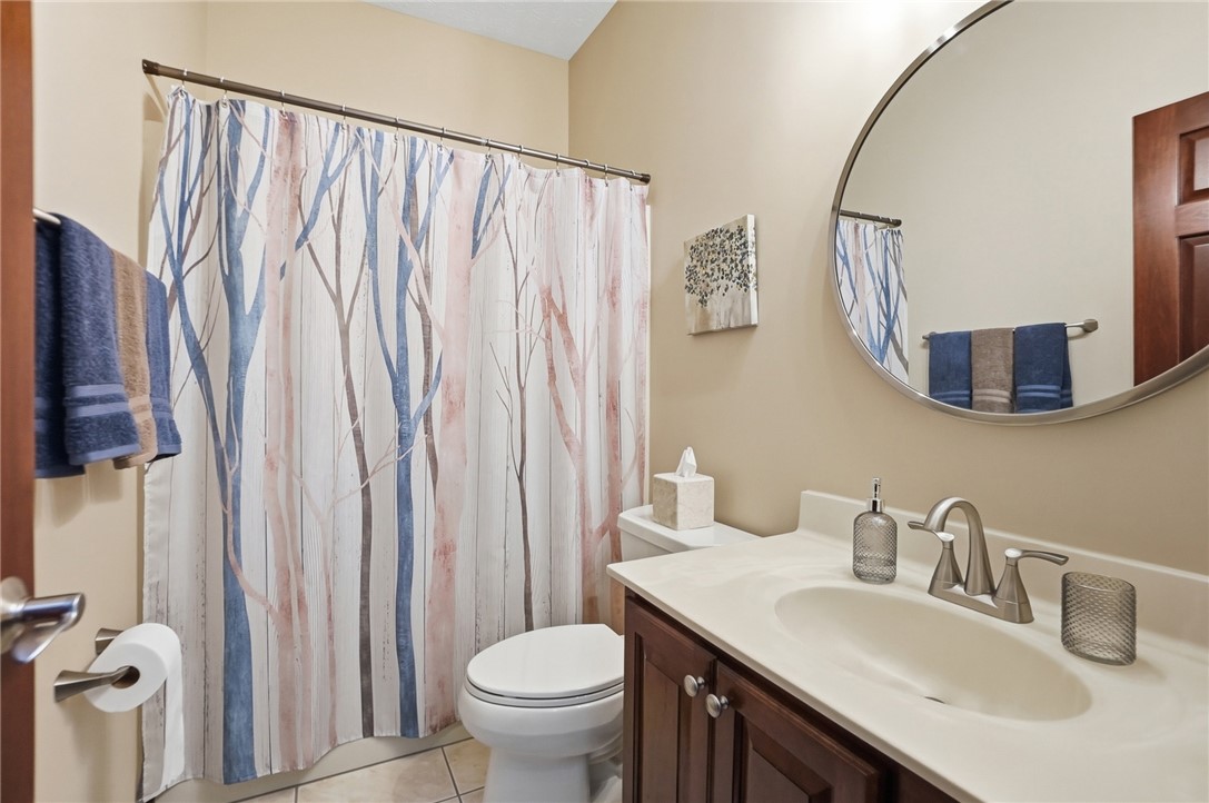 710 Governors Road Troy, OH 45373 - Photo 24 of 56 This bathroom features a contemporary vanity and a large circular mirror.
