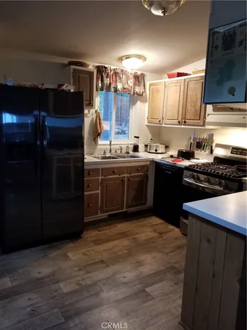 a kitchen with stainless steel appliances granite countertop a stove a sink dishwasher and a refrigerator