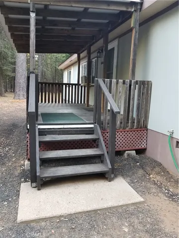 a view of staircase with wooden floor and a rug
