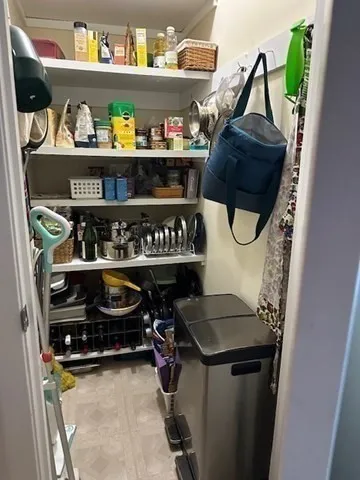 a bedroom with a bed and a mirror on dresser