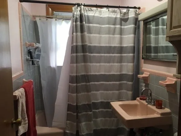 a bed with a bed and a painting on the wall