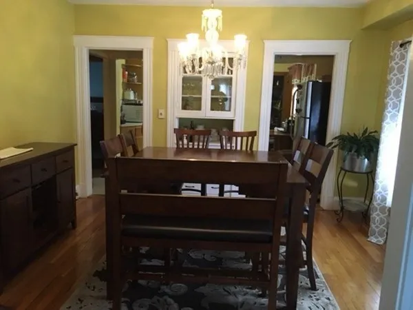 a view of a dining room with furniture and chandelier