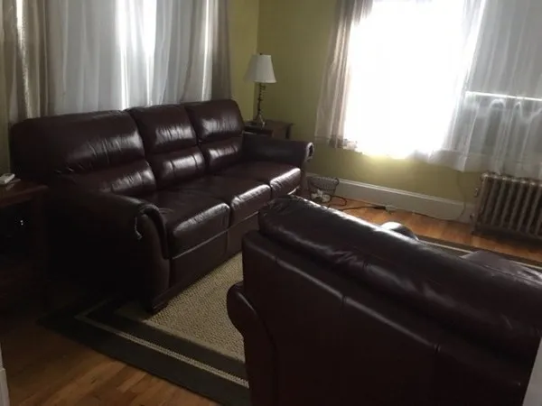 a black leather couch in a living room with a couch