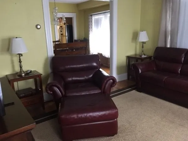 a living room with furniture and a lamp