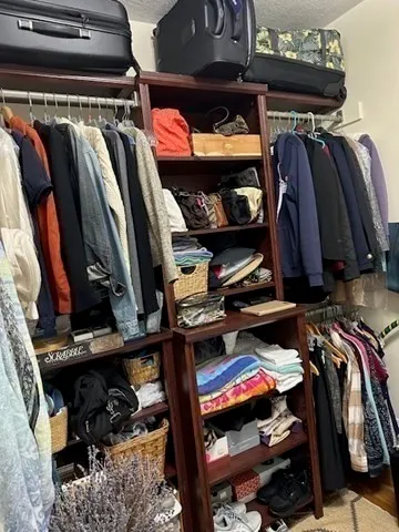 a view of walk in closet with clothes and shoes