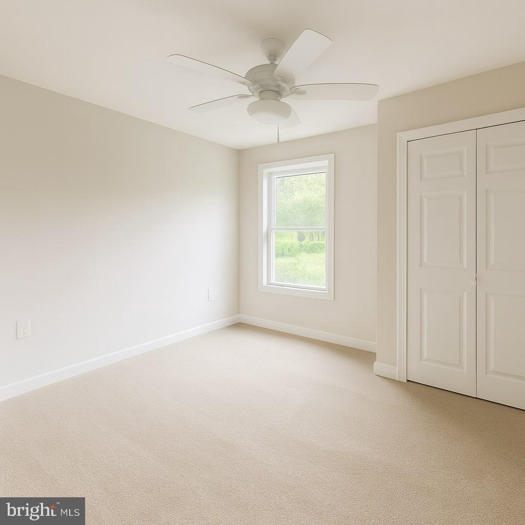 30568 Skipjack Circle, Unit 43 Princess Anne, MD 21853 - Photo 14 of 15 an empty room with a ceiling fan and a window
