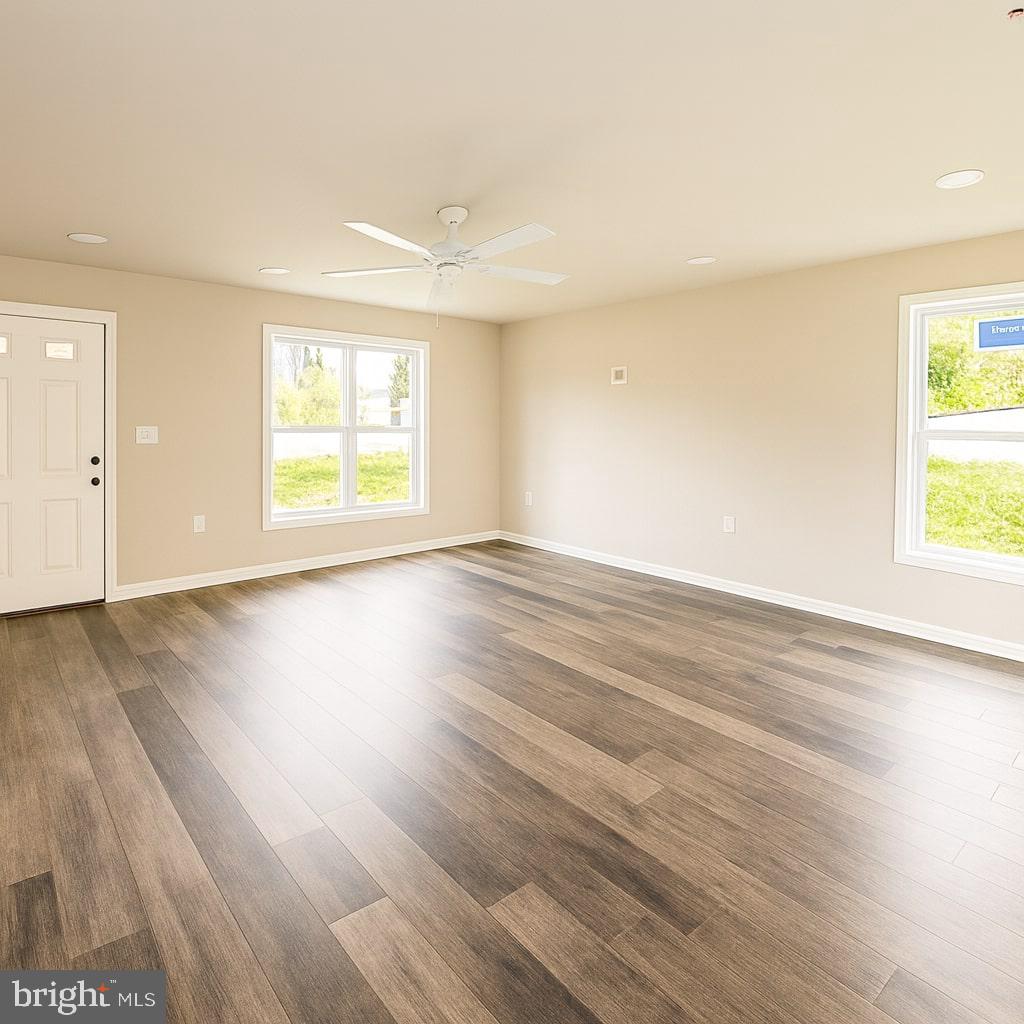 30568 Skipjack Circle, Unit 43 Princess Anne, MD 21853 - Photo 3 of 15 an empty room with wooden floor and windows