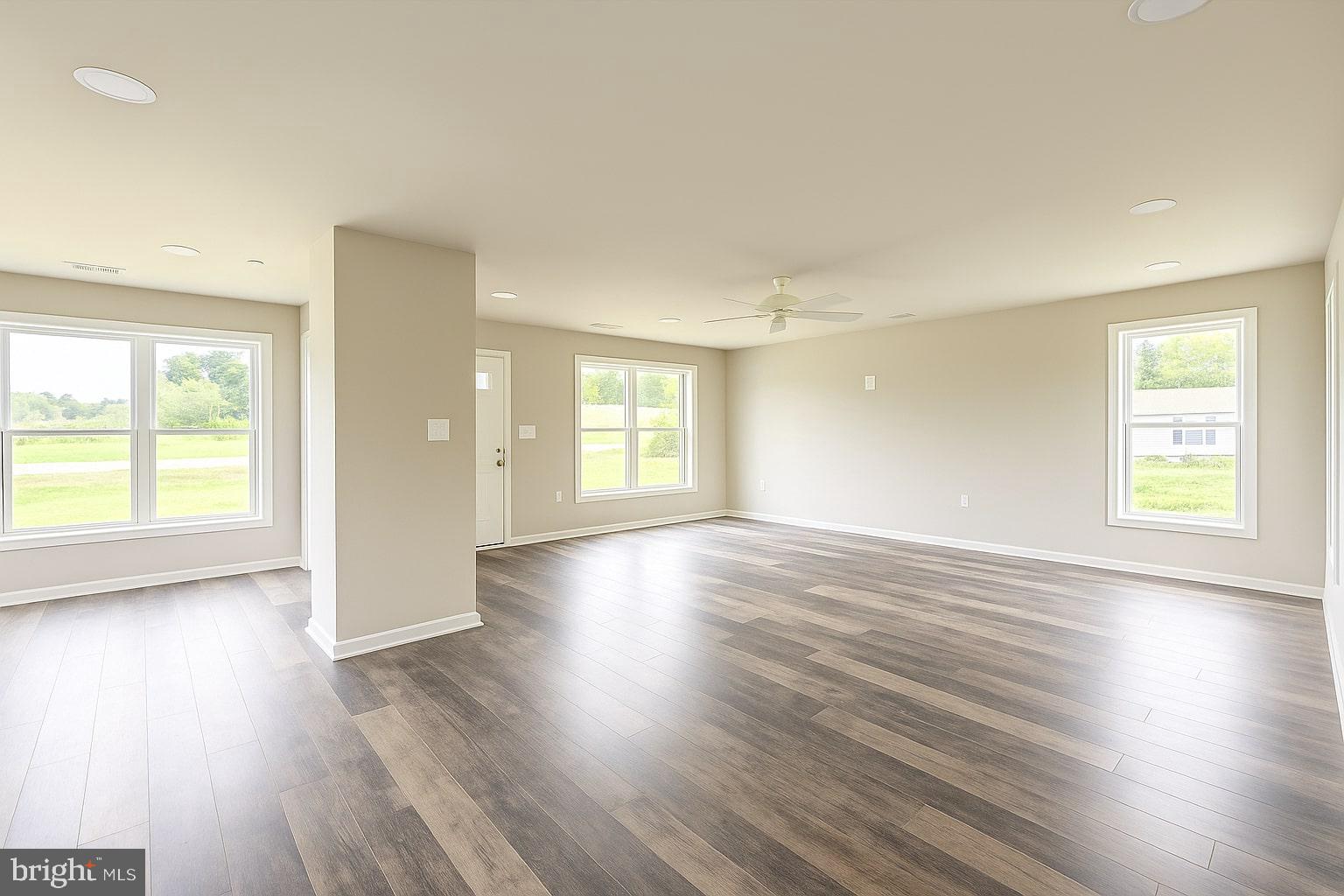30568 Skipjack Circle, Unit 43 Princess Anne, MD 21853 - Photo 4 of 15 an empty room with wooden floor and windows