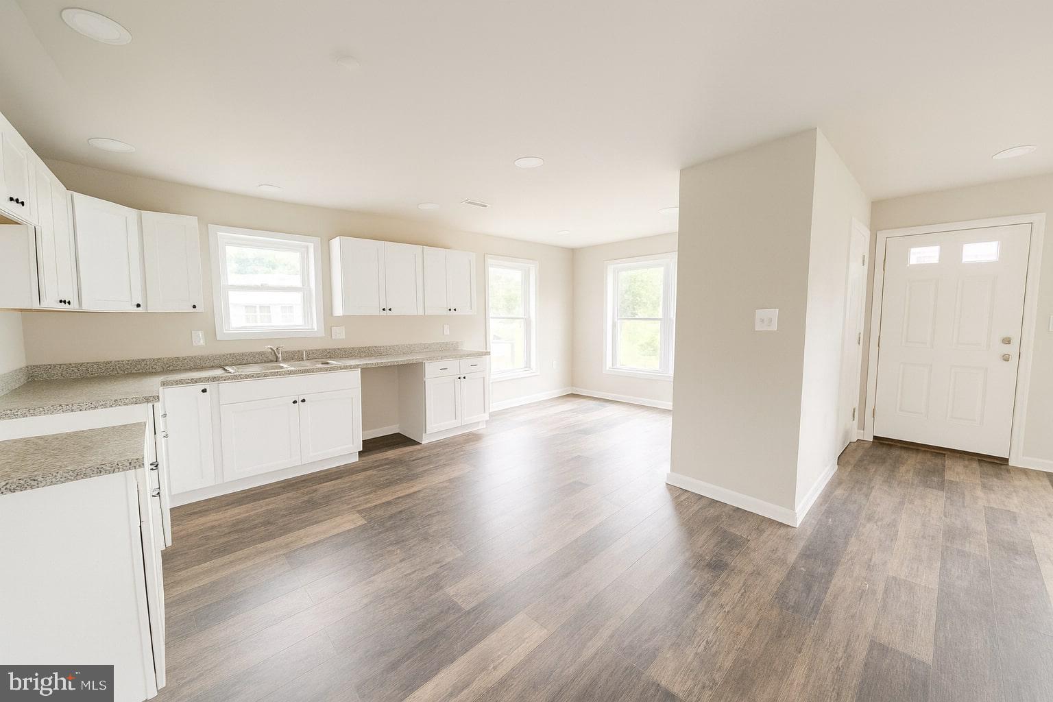 30568 Skipjack Circle, Unit 43 Princess Anne, MD 21853 - Photo 5 of 15 a kitchen with wooden floors and white appliances