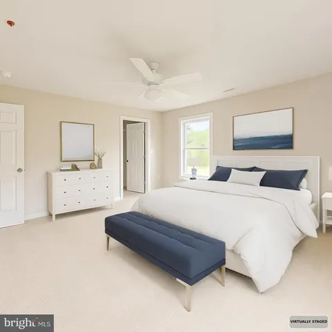 a spacious bedroom with a bed and a cabinets