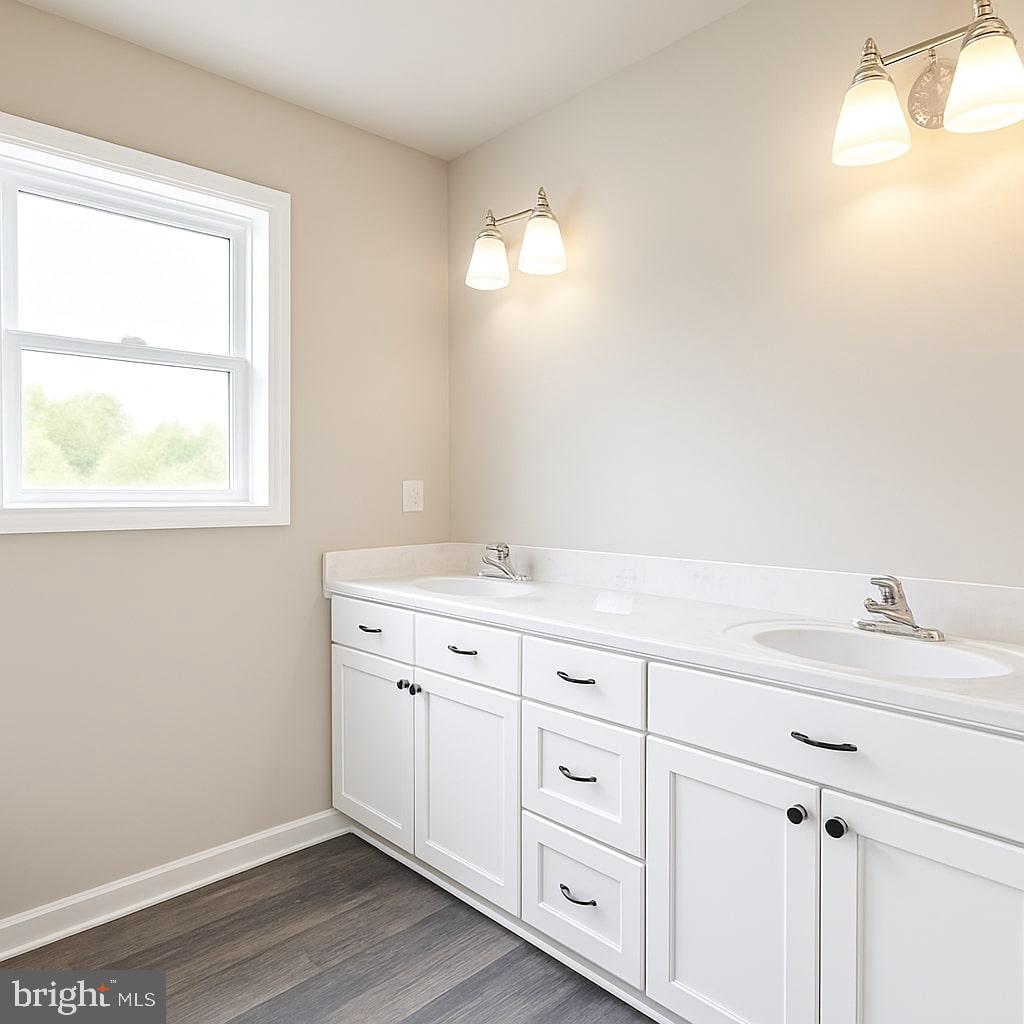 30568 Skipjack Circle, Unit 43 Princess Anne, MD 21853 - Photo 10 of 15 a bathroom with a double vanity sink and a mirror