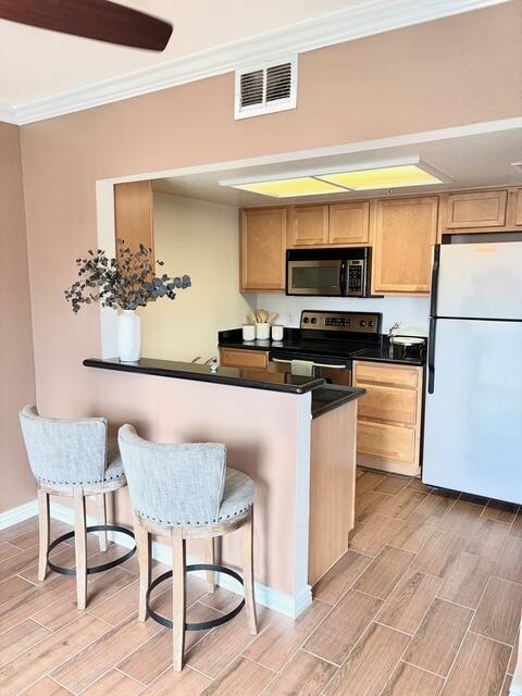 43376 Cook Street, Unit 88 Palm Desert, CA 92211 - Photo 12 of 38 a kitchen with stainless steel appliances a stove a sink cabinets and a dining table