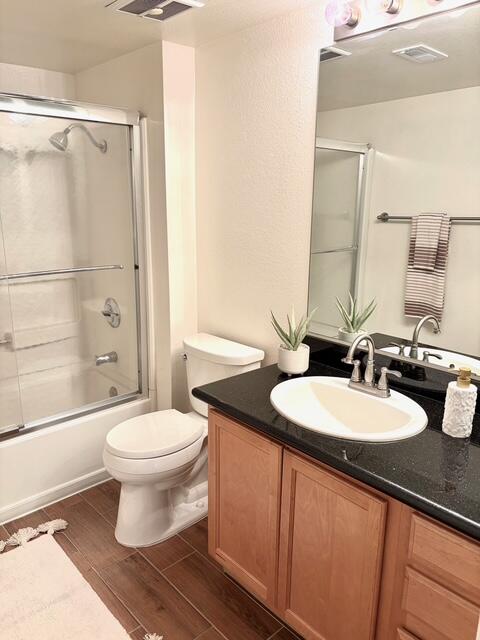43376 Cook Street, Unit 88 Palm Desert, CA 92211 - Photo 19 of 38 a bathroom with a granite countertop sink toilet a mirror and shower
