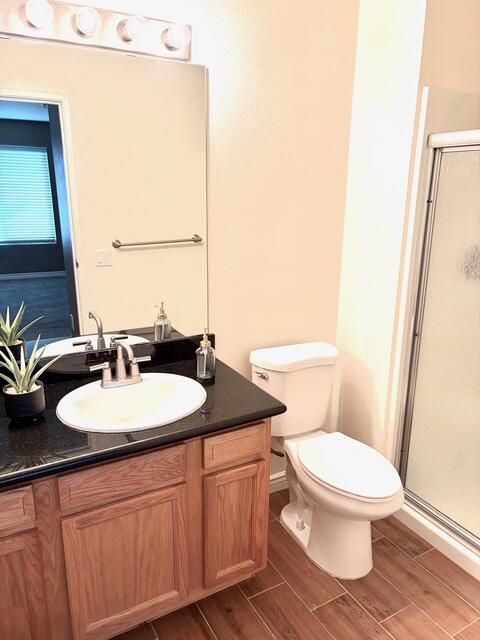43376 Cook Street, Unit 88 Palm Desert, CA 92211 - Photo 23 of 38 a bathroom with a granite countertop sink toilet a mirror and a shower