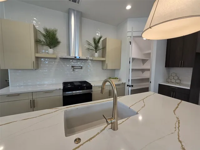 a kitchen with a sink a stove and cabinets