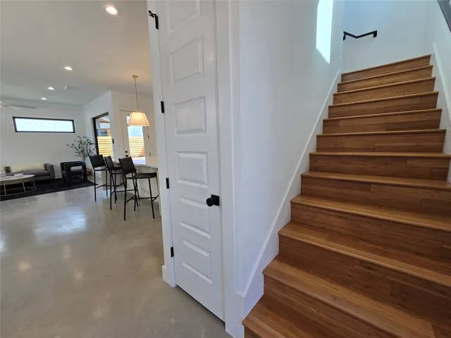 a view of a hallway with dining room and stairs