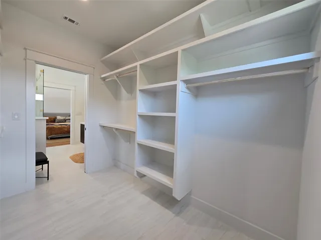 a view of a living room with furniture and a refrigerator