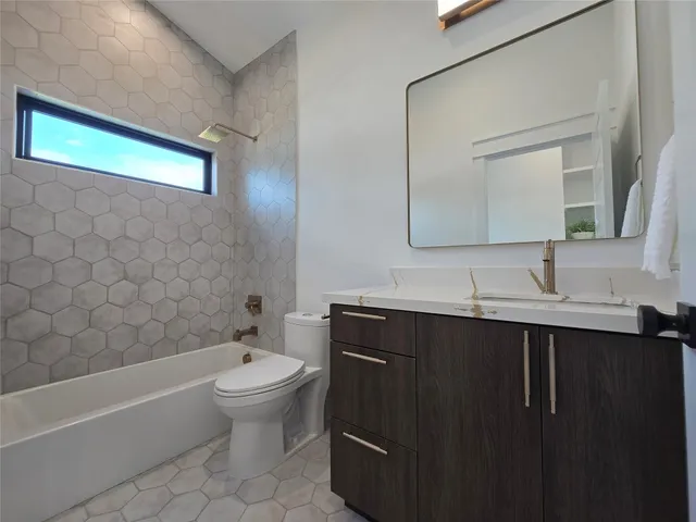 a bathroom with a sink a toilet and a bathtub