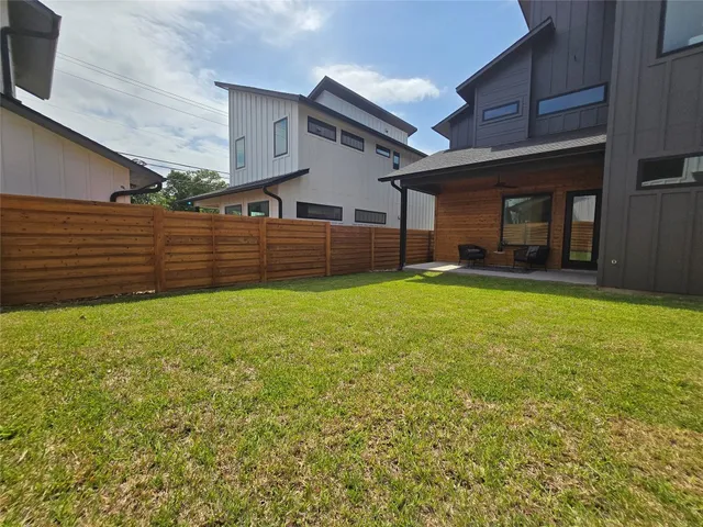 a view of a house with a yard and sitting area