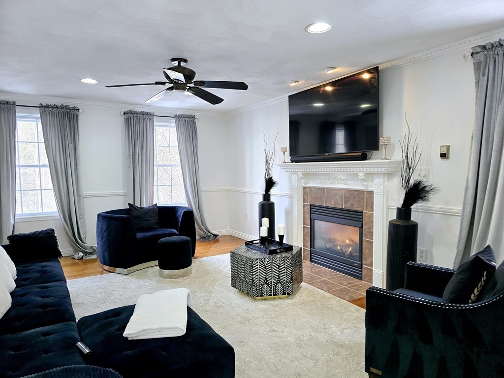 104 West Meadow Road Townsend, MA 01474 - Photo 18 of 42 a living room with furniture a fireplace and a flat screen tv