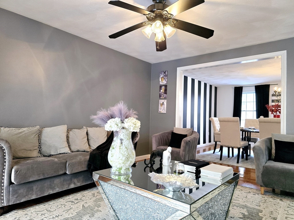 104 West Meadow Road Townsend, MA 01474 - Photo 26 of 42 a living room with furniture and a chandelier