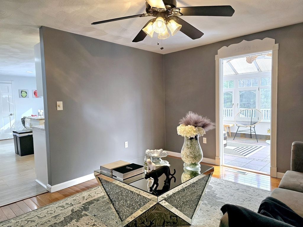 104 West Meadow Road Townsend, MA 01474 - Photo 27 of 42 a living room with furniture and a chandelier