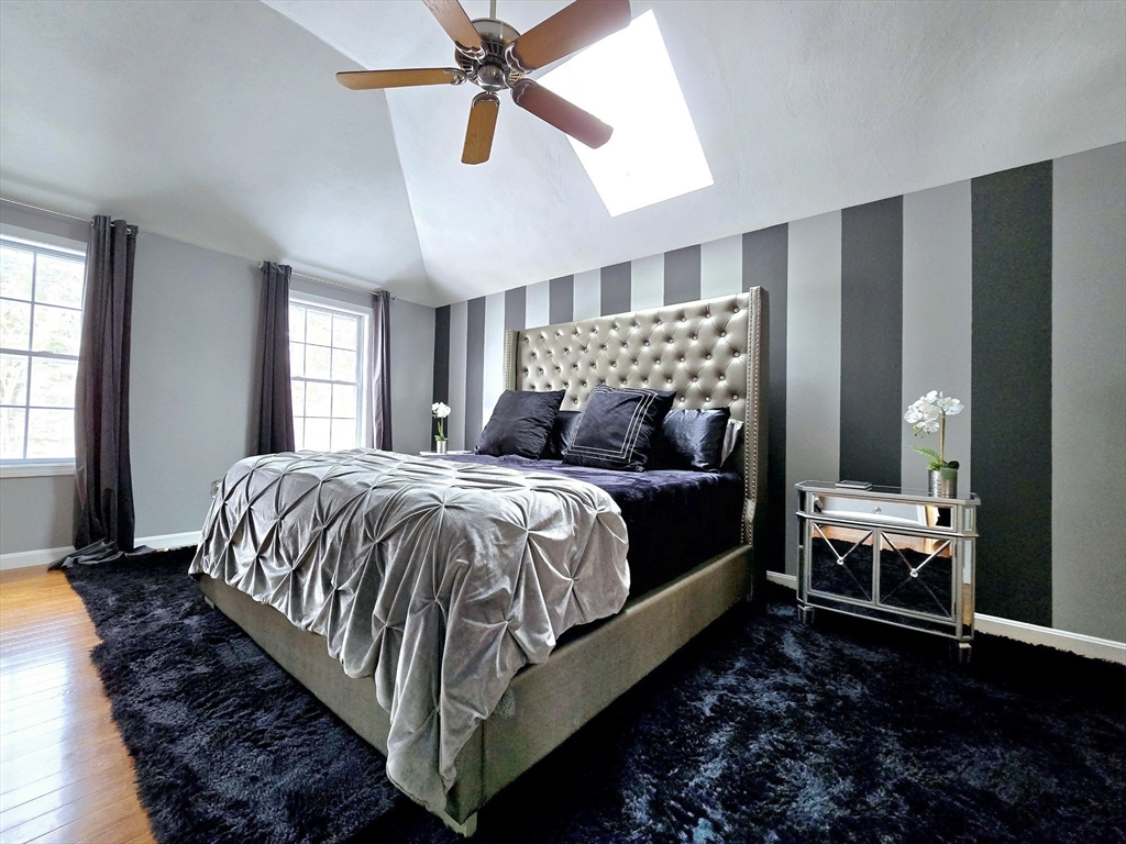 104 West Meadow Road Townsend, MA 01474 - Photo 28 of 42 a bedroom with a bed lamp and a fireplace