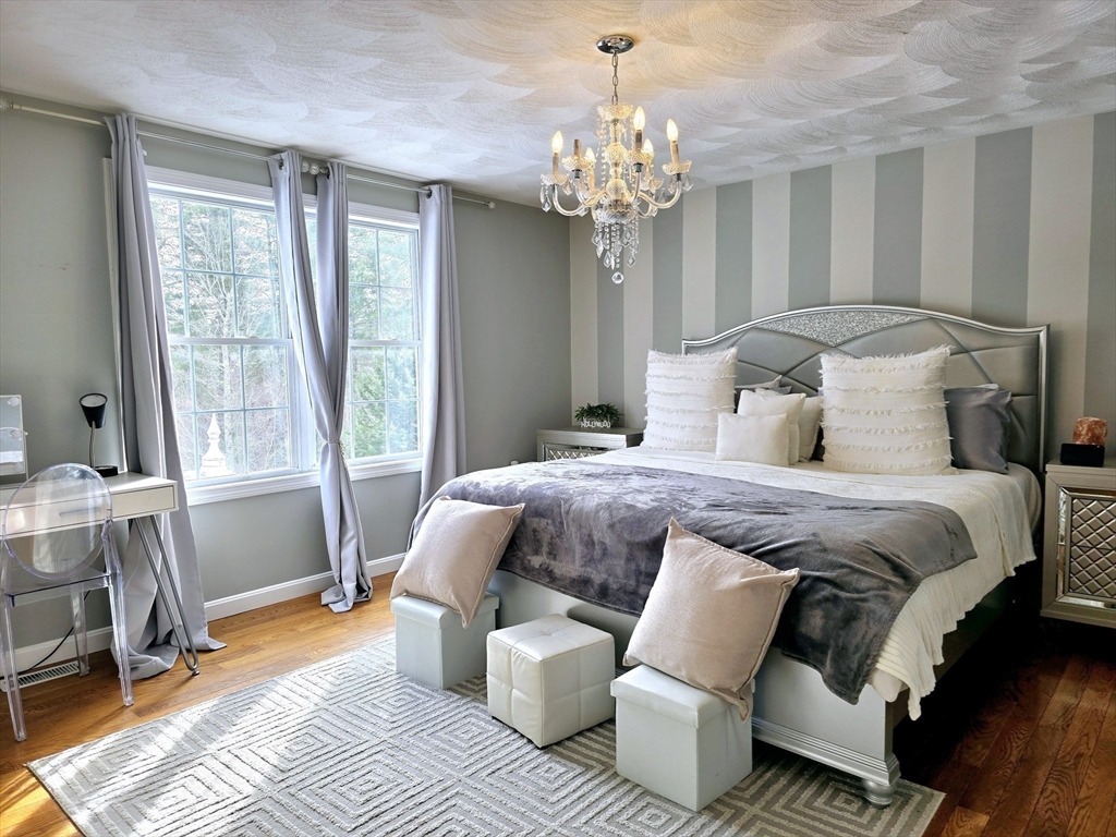 104 West Meadow Road Townsend, MA 01474 - Photo 31 of 42 a bed room with a bed and a chandelier