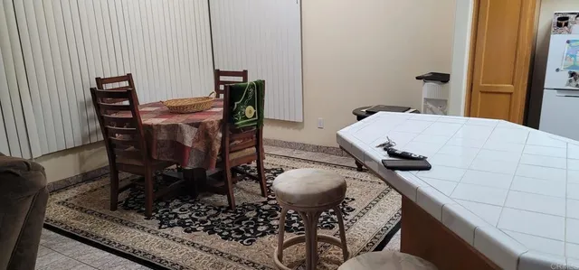 a dining room with furniture and window