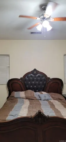a bedroom with a bed and window