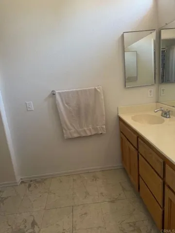 a bathroom with a sink toilet and a mirror