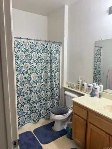 a bathroom with a sink toilet and a mirror