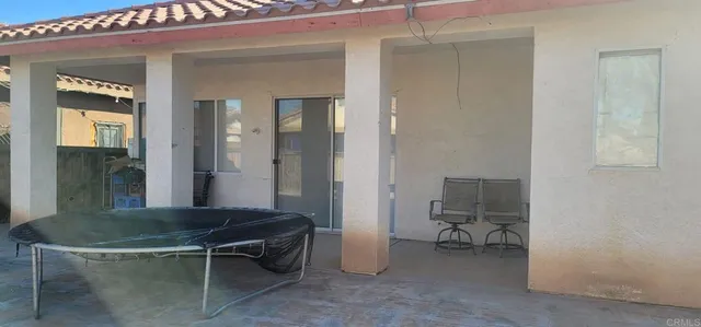 a view of a room that has a table and a chair in it