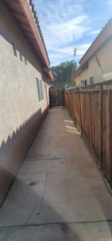 a view of swimming pool with wooden fence